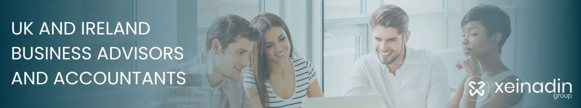 Professionals working together on a laptop with a woman on a phone call in the background, representing business advisors and accountants.