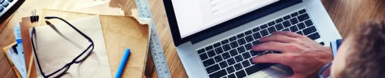 Top down view of a hand on a laptop