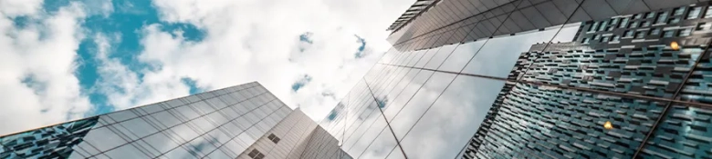 Shot from street level looking to the top of several skyscrapers