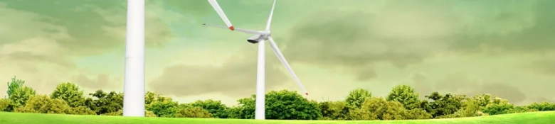 Wind turbines in a green landscape under a cloudy sky, symbolizing renewable energy.