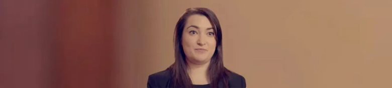 Professional headshot of Kate Ní Chonfhaola, a barrister, against a blurred background.