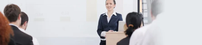 Female engineer presenting to colleagues in a professional training session.