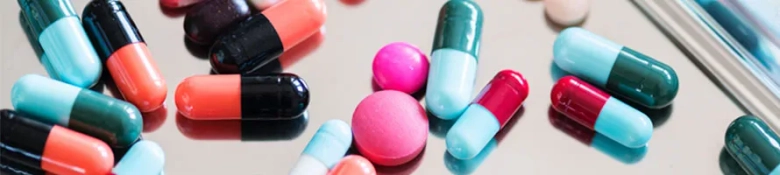 Multicoloured medicines scattered on table