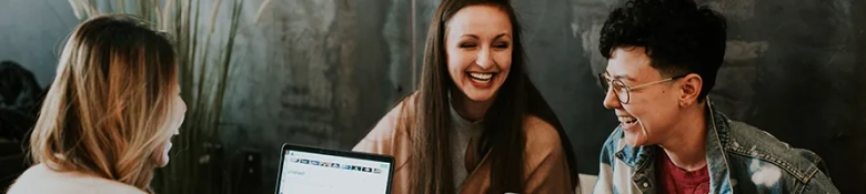 Students with laptops around a desk