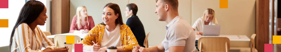 Two women and a man sitting around a table talking to each other