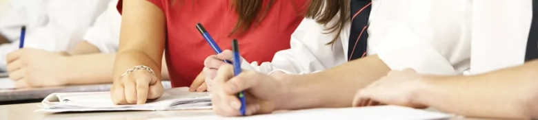 Image of three people at a desk 