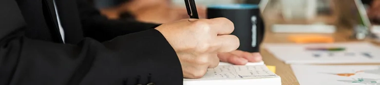 Modern office where meeting is held and people write their notes