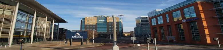 Modern buildings in a business district with clear signage, representing economic development at the border of Ireland and Northern Ireland.